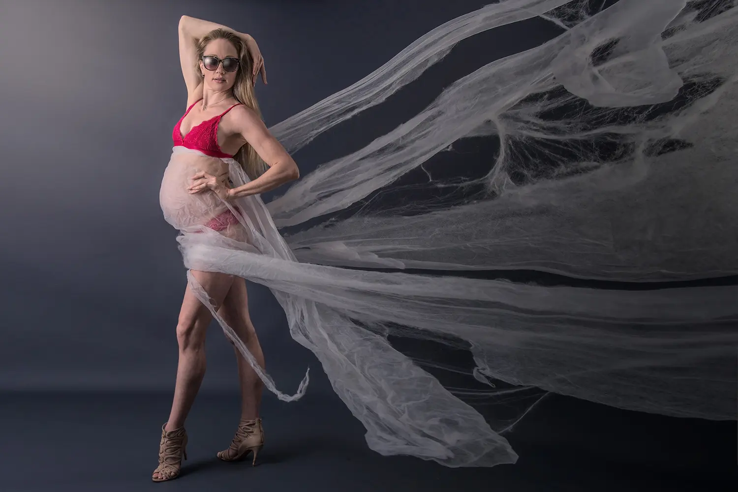 Pregnant woman in lingerie and sunglasses 